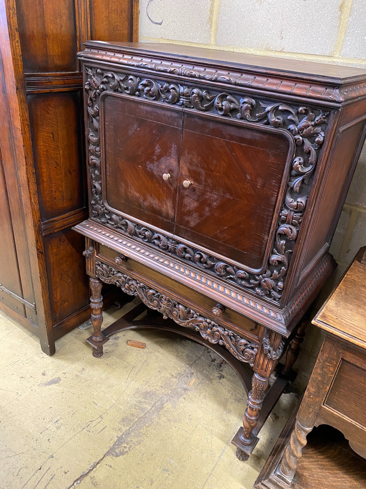 A 17th century style oak cocktail cabinet on stand, width 90cm, depth 50cm, height 137cm